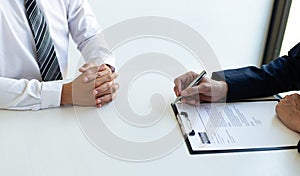 Business people hold resume documents, interviews for the work experience of young men applying as financial accountants for the c