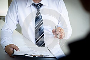 Business people hold resume documents, interviews for the work experience of young men applying as financial accountants for the c