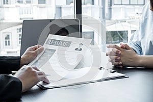 Business people hold a resume and talk to job applicants for job interviews about careers and Her personal history in the company