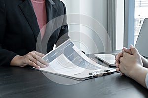 Business people hold a resume and talk to job applicants for job interviews about careers and Her personal history in the company