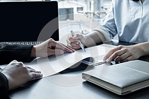 Business people hold a resume and talk to job applicants for job interviews about careers and Her personal history in the company