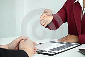 Business people hold a resume and talk to job applicants for job interviews about careers and Their personal history in the