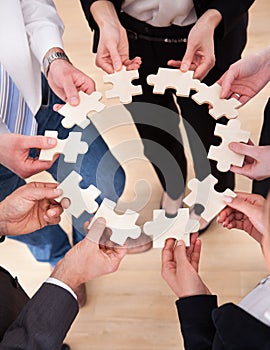 Business people holding jigsaw puzzle
