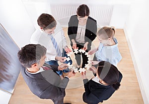 Business people holding jigsaw puzzle