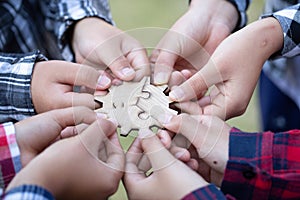 Business people Holding Jigsaw Puzzle, group of business people using a jigsaw puzzle to demonstrate the need to work in the same