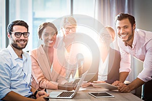 Business people holding laptop, mobile phone and digital tablet