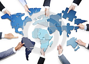 Business People with Jigsaw Forming World Map