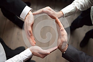 Business people join hands in circle, protection and support con