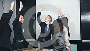 Business people join putting hands as team during their meeting