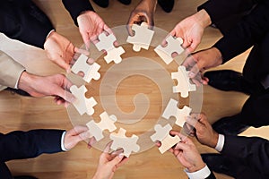 Business People Joining Puzzle Pieces In Office