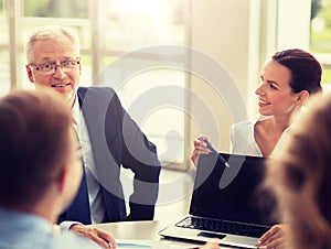 Business people with laptop meeting in office