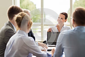 Business people with laptop meeting in office