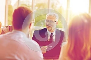 Business people with laptop meeting in office