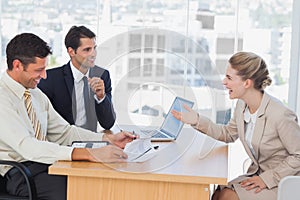 Business people laughing with interviewee