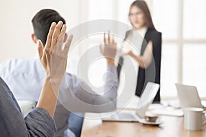 Business people laughing together while discussing paperwork during a meeting.