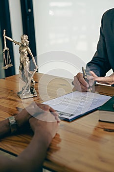 Business people or lawyers discussing contracts or business deals at a law firm. Justice advice service concept with hammer and go