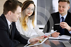 Business people or lawyers discussing questions at meeting in modern office. Unknown businessman and woman with