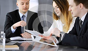 Business people or lawyers discussing questions at meeting in modern office. Unknown businessman and woman with