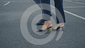 Business people legs stepping city pavement hurrying on meeting close up.