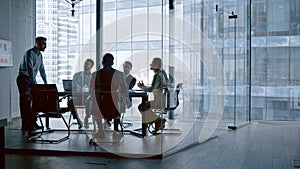 Business people listening the presenter while sitting at desk