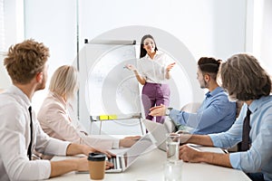 Business people listening to leader on meeting in office.