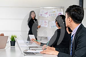 Business people listening to meeting presentation.