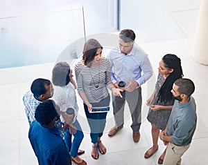 Business people, lobby and team in circle with tablet for brainstorming, strategy or agenda in morning. Woman, above and
