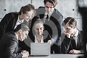 Business people look at laptop