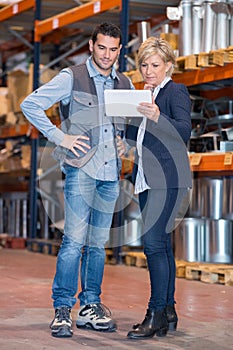 business people looking tablet in warehouse