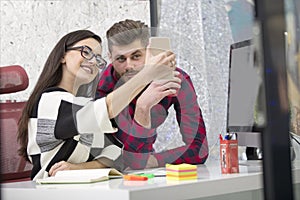 Business people making photos on mobile or smart phone and happy smiling. Workers having break time. Business concept.