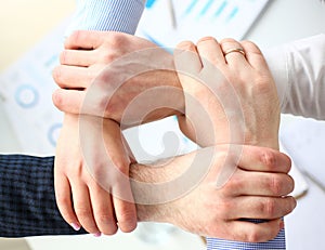 Business people making routine sign with hands for teamspirit above working table