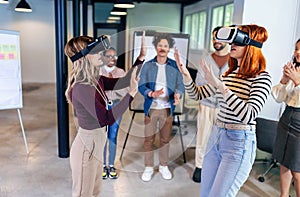 Business people making team training exercise during team building seminar using VR glasses