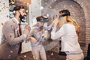 Business people making team training exercise during team building seminar using VR glasses