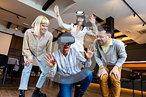 Business people making team training exercise during team building seminar using VR glasses