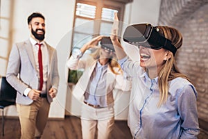 Business people making team training exercise during team building seminar using VR glasses