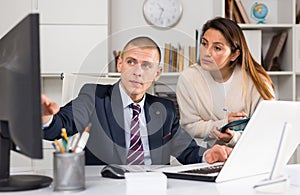 Business people man and woman discussing paperwork