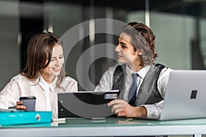 Business people man and woman working together with a laptop computer in office