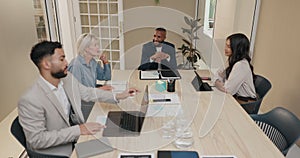 Business people, meeting and documents in boardroom for group discussion, start or review at startup. Men, women and