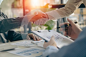 Business people meeting in modern room Hand in hand for business success Employees shake hands with each other, brainstorming for