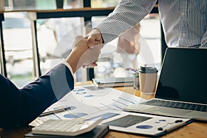 Business people meeting in modern room Hand in hand for business success Employees shake hands with each other, brainstorming for