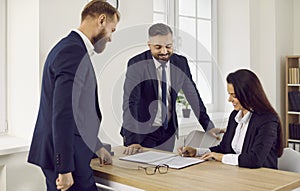 Business people at meeting in office sign contract confirming partnership agreement.