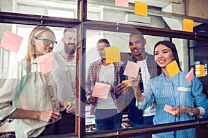 Business people meeting at office and use post it notes to share idea. Brainstorming concept. Sticky note on glass wall