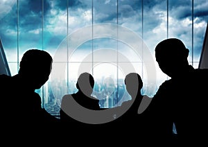 Business people at a meeting silhouettes against building