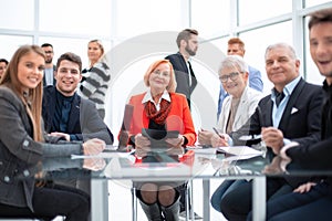 Business people during a meeting sitting around a glass table