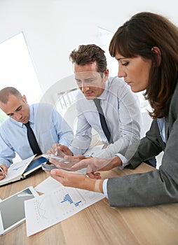 Business people in meeting using electronical devices