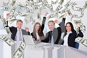 Business people with money rain in conference room