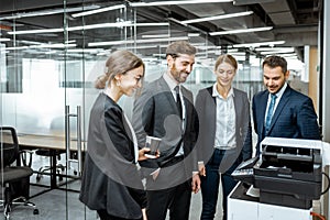 Business people near the copier in the hallway