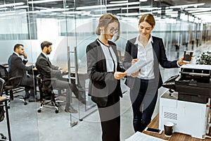 Business people near the copier in the hallway