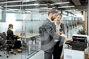 Business people near the copier in the hallway