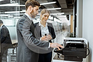 Business people near the copier in the hallway